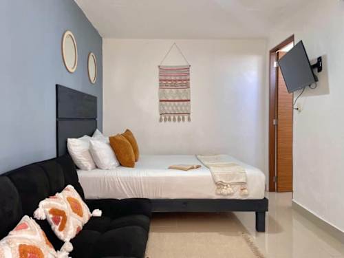 Bedroom with double bed and sofa
