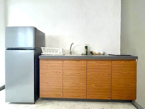 Kitchenette with refrigerator and essentials