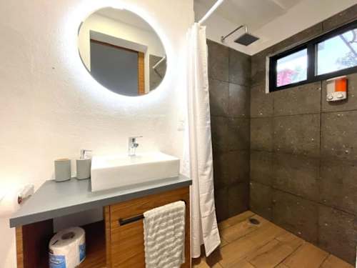 Private bathroom with round vanity mirror