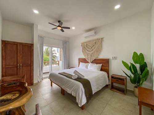 Private bedroom with king bed and macrame headboard