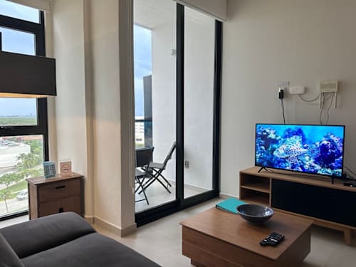 Living room with smart TV and sofa bed