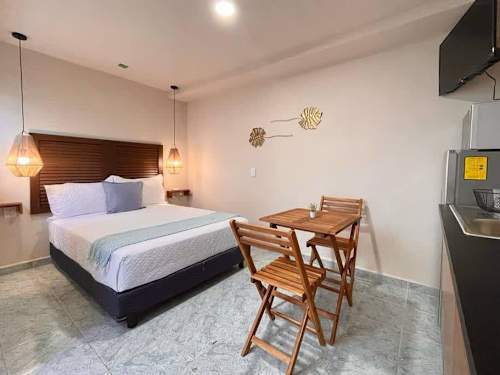 Studio with double bed and dining table