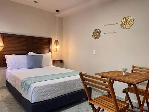 Double bed and dining area in the studio