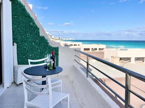 Breezy oceanfront terrace overlooking turquoise water, sip a drink and take in the endless sea