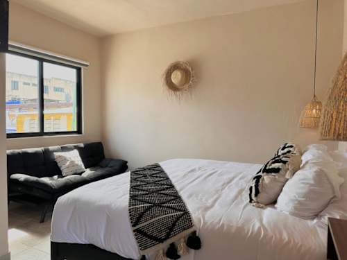 King bed by the window with a sofa
