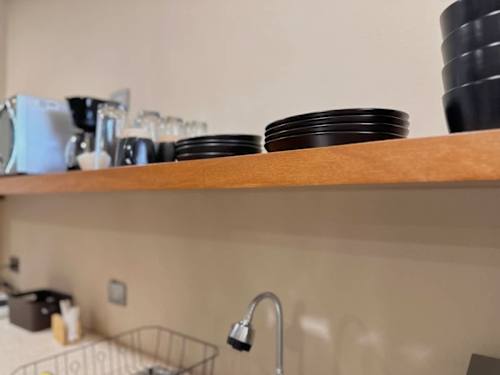 Kitchen shelf with dishware and kettle