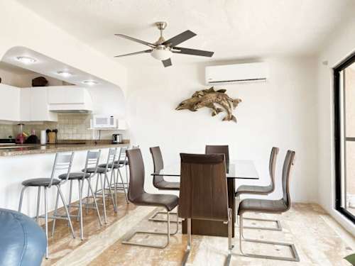 Dining table beside the equipped kitchen