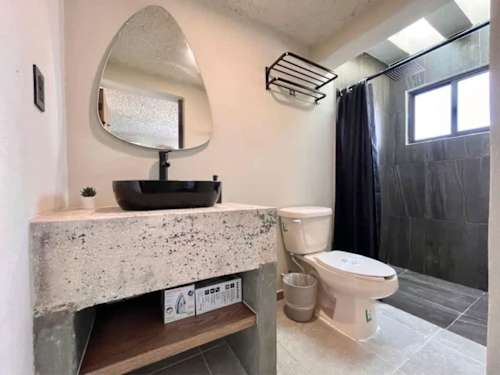 Full private bathroom with vanity and mirror