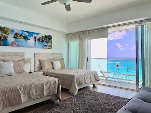Open studio living area with sofa and ocean view