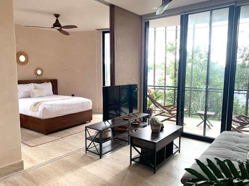 Living room with sofa, ceiling fan and A/C