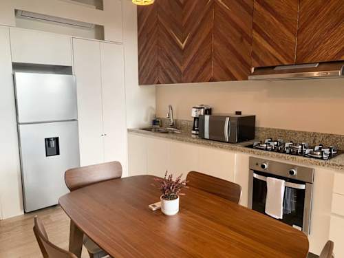 Kitchen with oven, stove and wine glasses