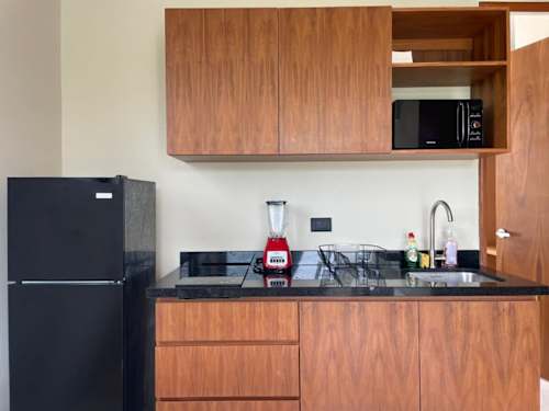 Fully equipped kitchen with refrigerator and stove