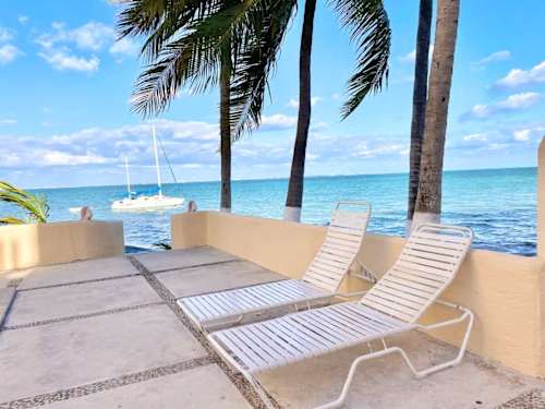 Sun loungers by the pool, steps from the sea