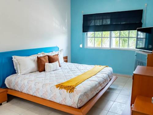 Master bedroom - King bed with Smart TV and blue accent wall