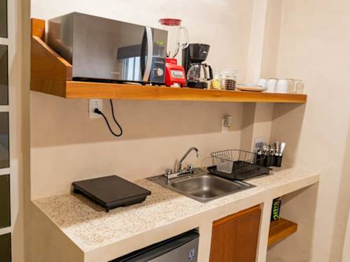 Kitchenette with cookware and appliances