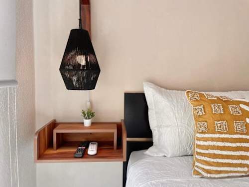 Comfortable double bed with nightstand and reading lamp