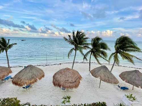 Shared beach with palapas and white sand