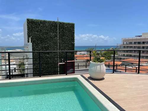 Shared rooftop pool with ocean views