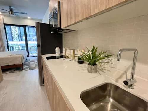 Kitchenette with sink and cookware