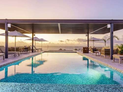 Shared rooftop pool and jacuzzi with sea views