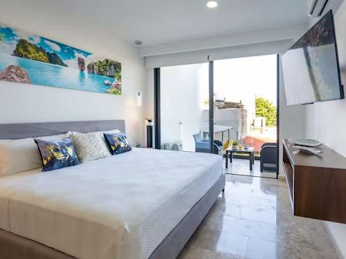 Bright studio with a king bed opening to your own private balcony, second-floor comfort