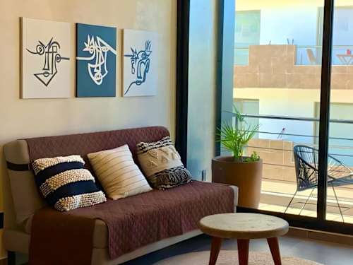 Living room with sofa bed, smart TV and balcony