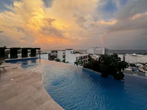 Shared rooftop pool at sunset