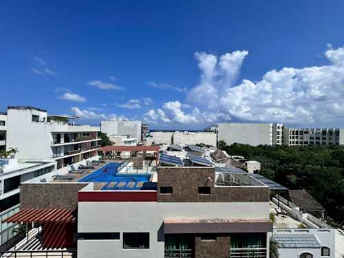 Shared rooftop pool with Playa del Carmen views