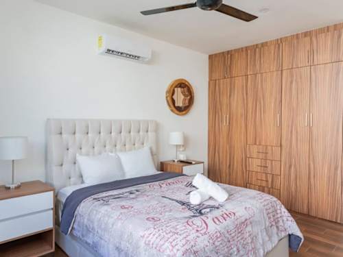 Bedroom - Queen bed with A/C, ceiling fan, wardrobe and smart TV