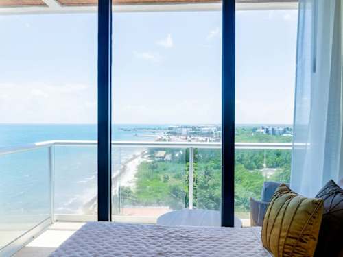 Bedroom with floor-to-ceiling ocean views