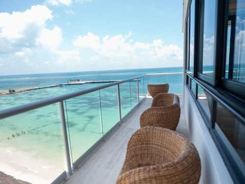 Oceanfront balcony with loungers