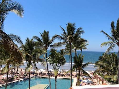 Shared resort pool with sun loungers