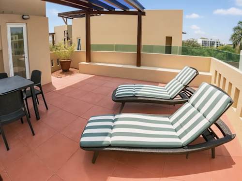 Private rooftop terrace with sun loungers.