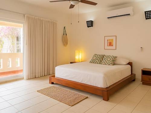 Master bedroom with queen bed and air conditioning.