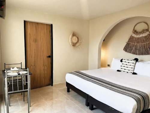 Studio with king bed and dining area.