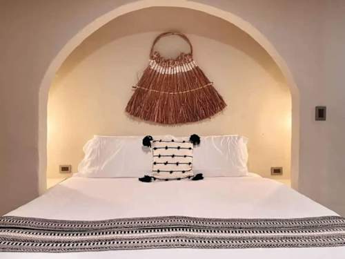 King bed with handcrafted headboard and decor.