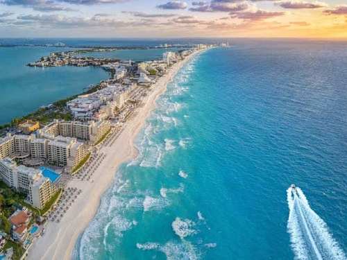Nearby: Cancun Hotel Zone and turquoise Caribbean sea.