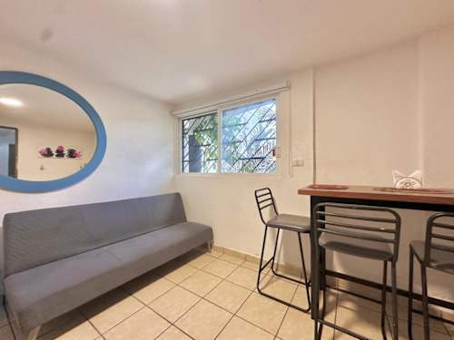 Studio living area with sofa bed and dining table