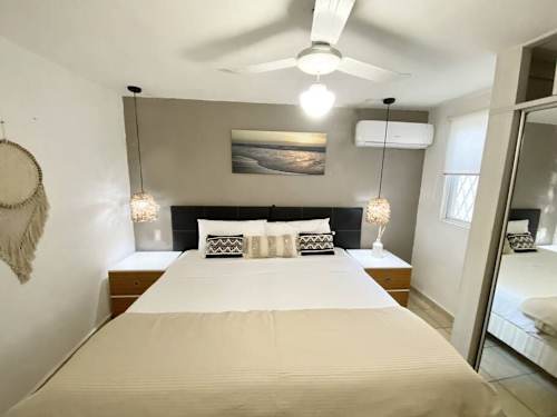 Bedroom with ceiling fan and natural light