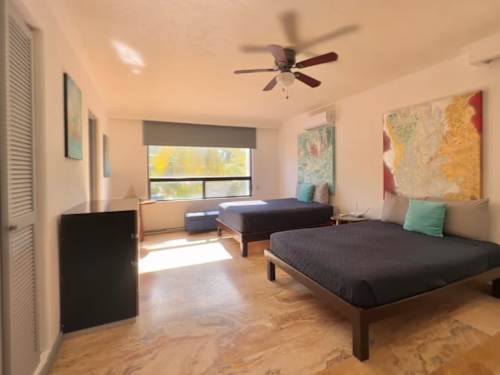 Bedroom with ceiling fan and balcony