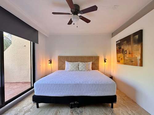 Bedroom with queen bed and ceiling fan