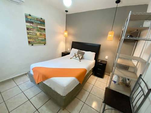 Cozy bedroom with a double bed and space-saving bunk, comfortable for friends or family