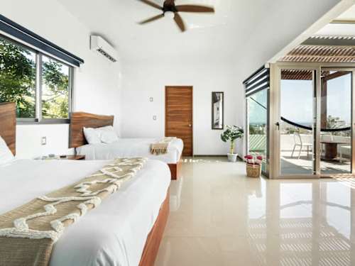 Bright open living and dining area with ceiling fan