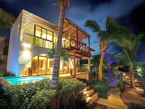 Villa exterior with private plunge pool at dusk