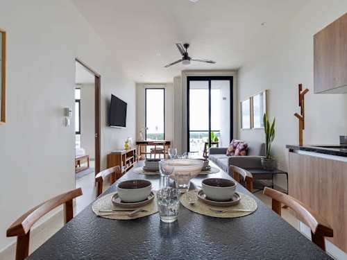 Open dining area, kitchen and living room with balcony