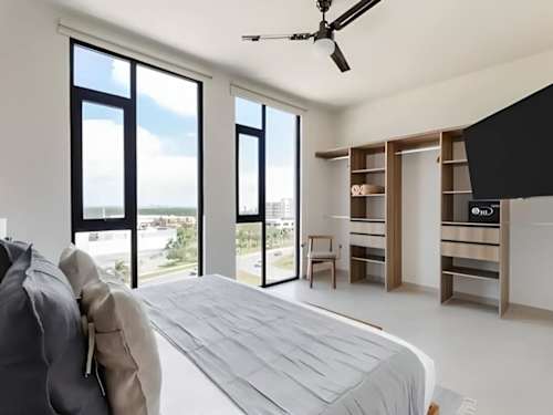 Bedroom with wardrobe and large windows