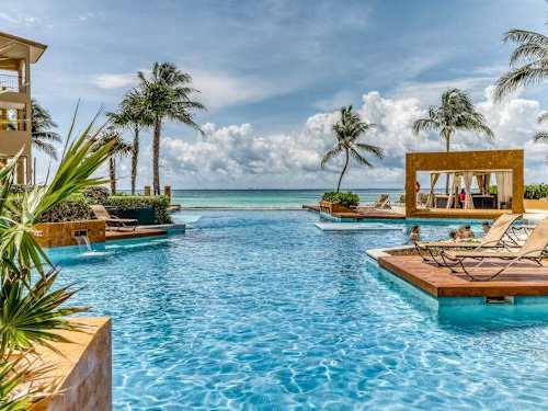 Shared infinity pool and palapa with ocean view