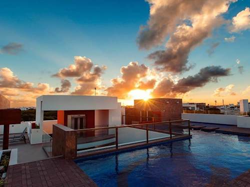 Shared rooftop pool at sunset