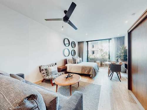 Living area with sofa bed and ceiling fan