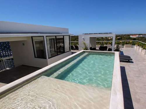 Shared rooftop pool with city and sea views